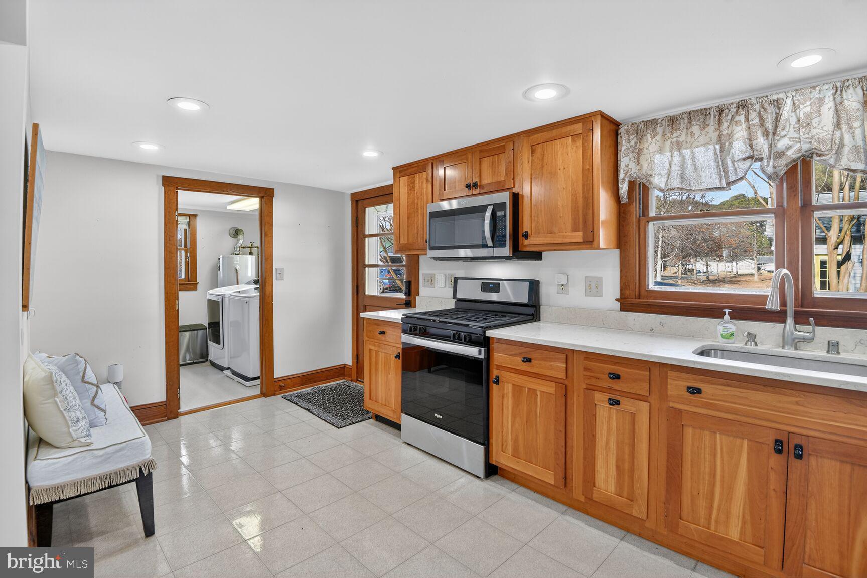 22769 Almost Neavitt Road Bozman, MD 21612 - Photo 25 of 44 a kitchen with stainless steel appliances granite countertop a stove and a sink