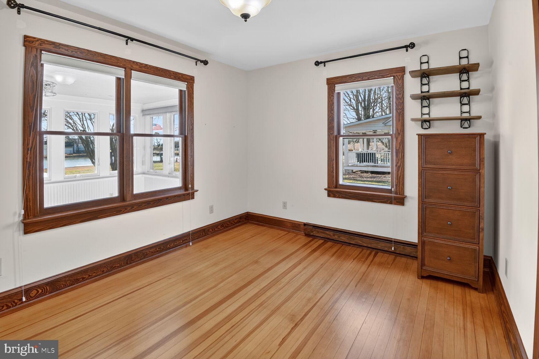 22769 Almost Neavitt Road Bozman, MD 21612 - Photo 28 of 44 an empty room with wooden floor and windows