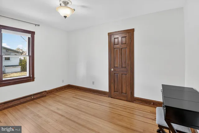 a view of a room with wooden floor and windows