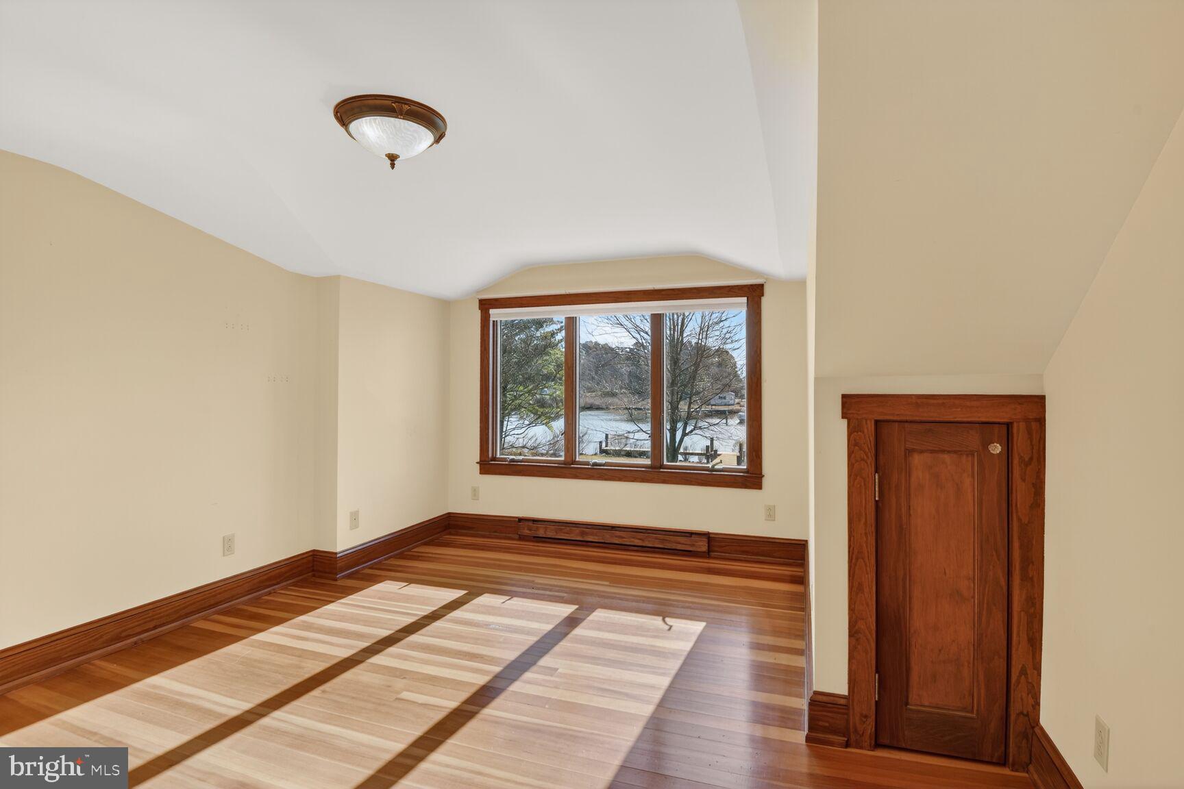 22769 Almost Neavitt Road Bozman, MD 21612 - Photo 31 of 44 a view of an empty room with wooden floor and a window