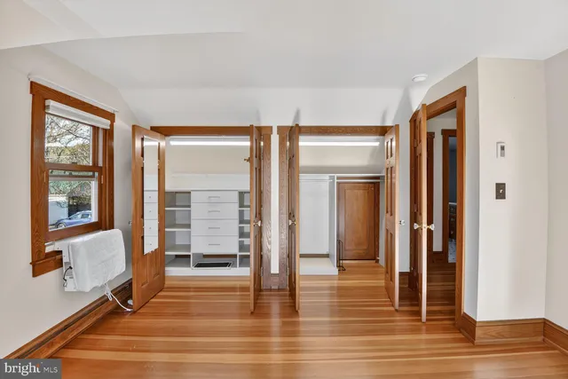 a bathroom with a sink a toilet a mirror and a window