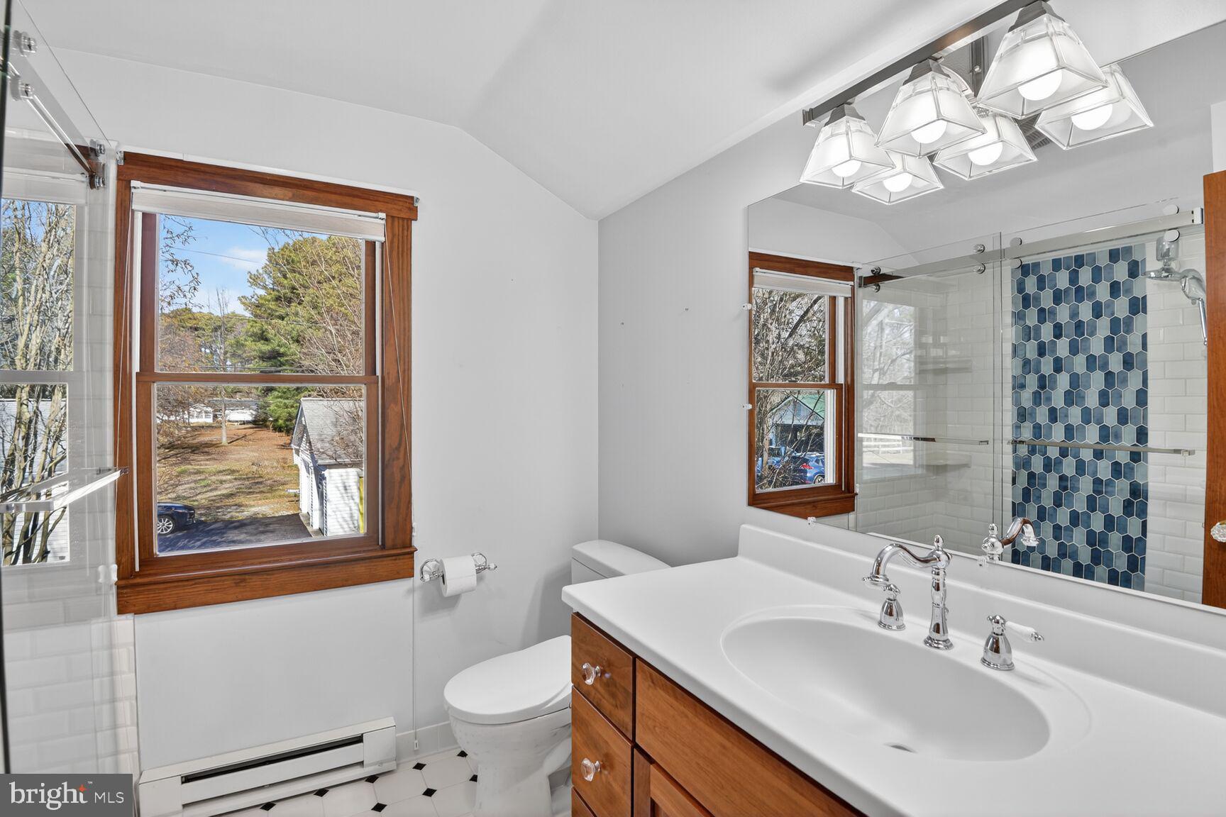 22769 Almost Neavitt Road Bozman, MD 21612 - Photo 34 of 44 a bathroom with a sink a toilet a mirror and a window