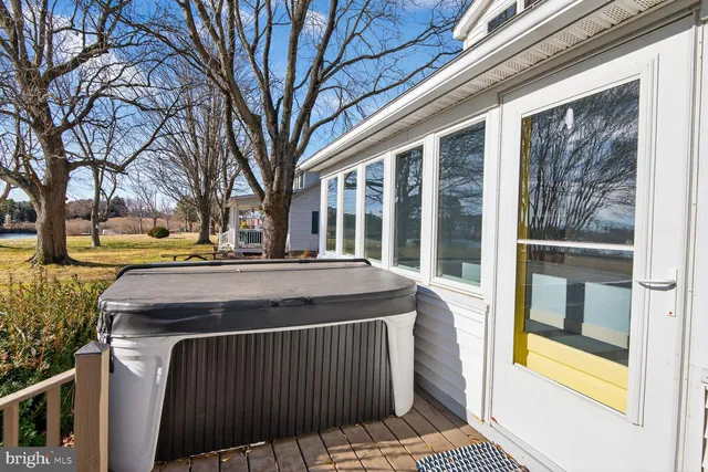 a front view of a house with a yard covered in snow