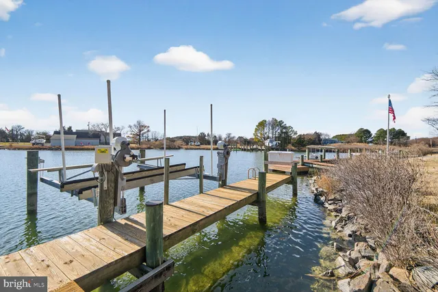 a view of a swimming pool with outdoor seating and lake view