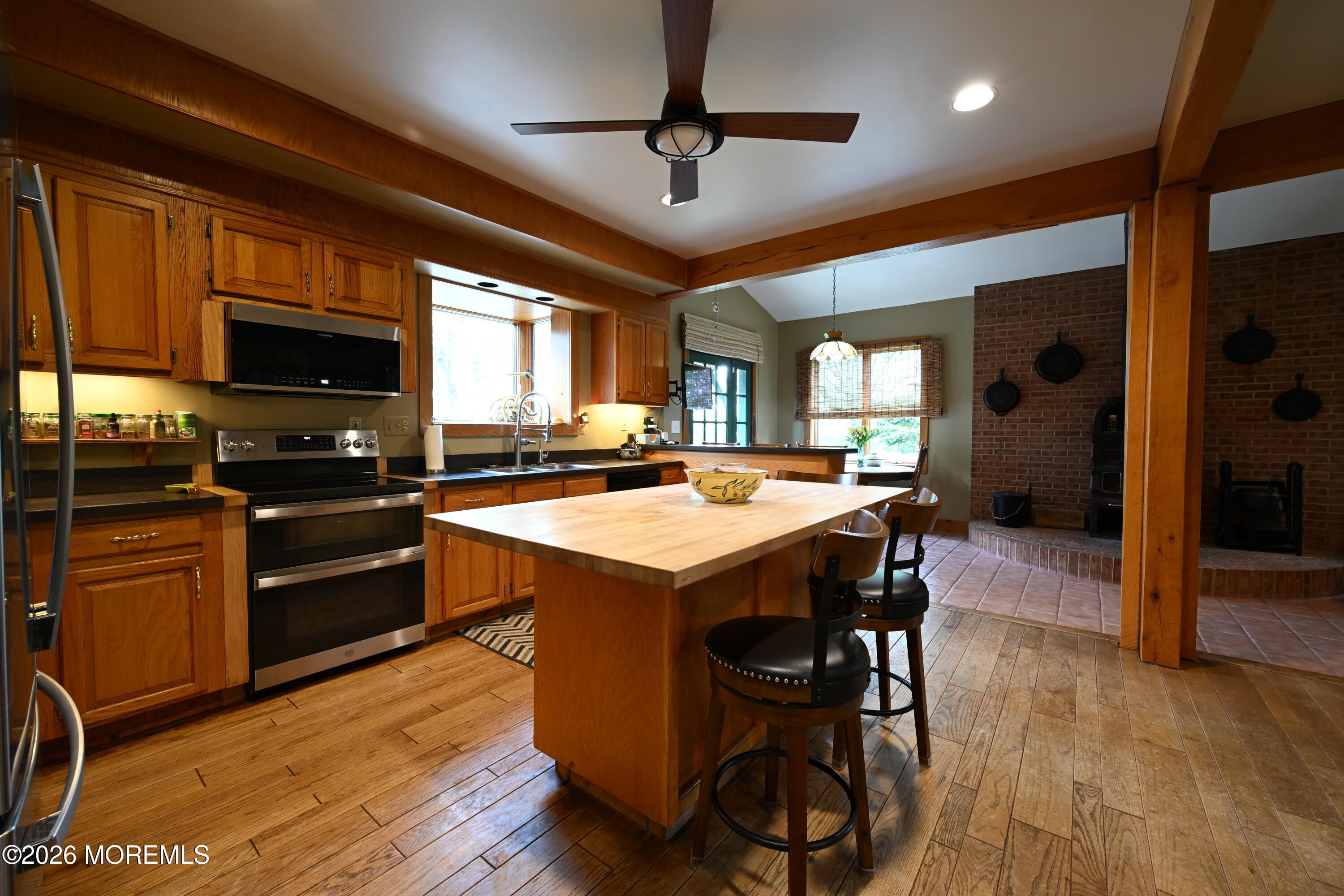 20 Hluchy Road Robbinsville, NJ 08691 - Photo 6 of 38 a kitchen with stainless steel appliances kitchen island granite countertop a stove a refrigerator a sink a dining table and chairs with wooden floor