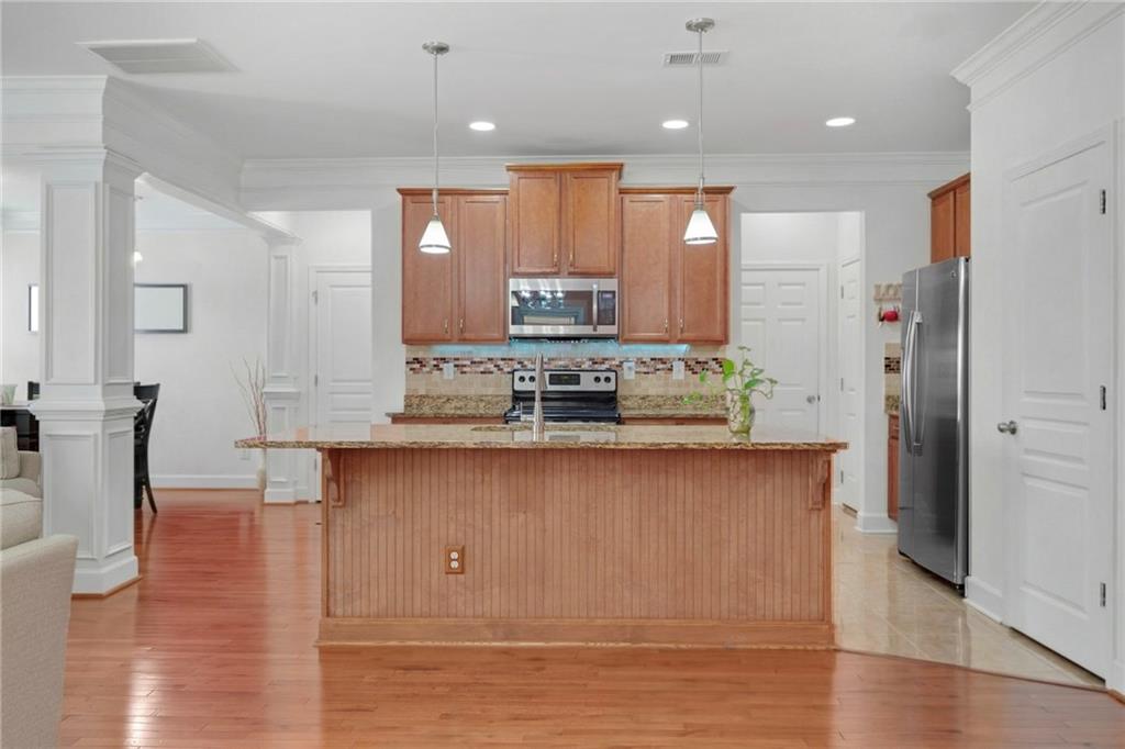 2325 Arnold Mill Road Northwest Lawrenceville, GA 30044 - Photo 14 of 40 a large kitchen with stainless steel appliances granite countertop a stove a sink and a refrigerator