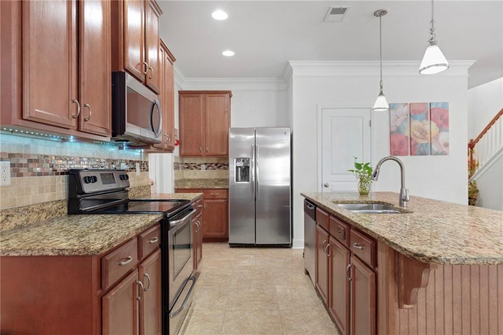 2325 Arnold Mill Road Northwest Lawrenceville, GA 30044 - Photo 18 of 40 a kitchen with stainless steel appliances granite countertop a sink a stove and a refrigerator