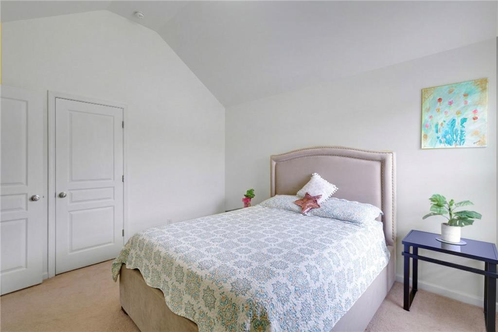 2325 Arnold Mill Road Northwest Lawrenceville, GA 30044 - Photo 20 of 40 a bedroom with a bed table and a potted plant