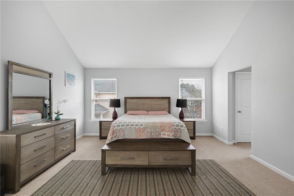 2325 Arnold Mill Road Northwest Lawrenceville, GA 30044 - Photo 29 of 40 a large bedroom with a bed and wooden floor