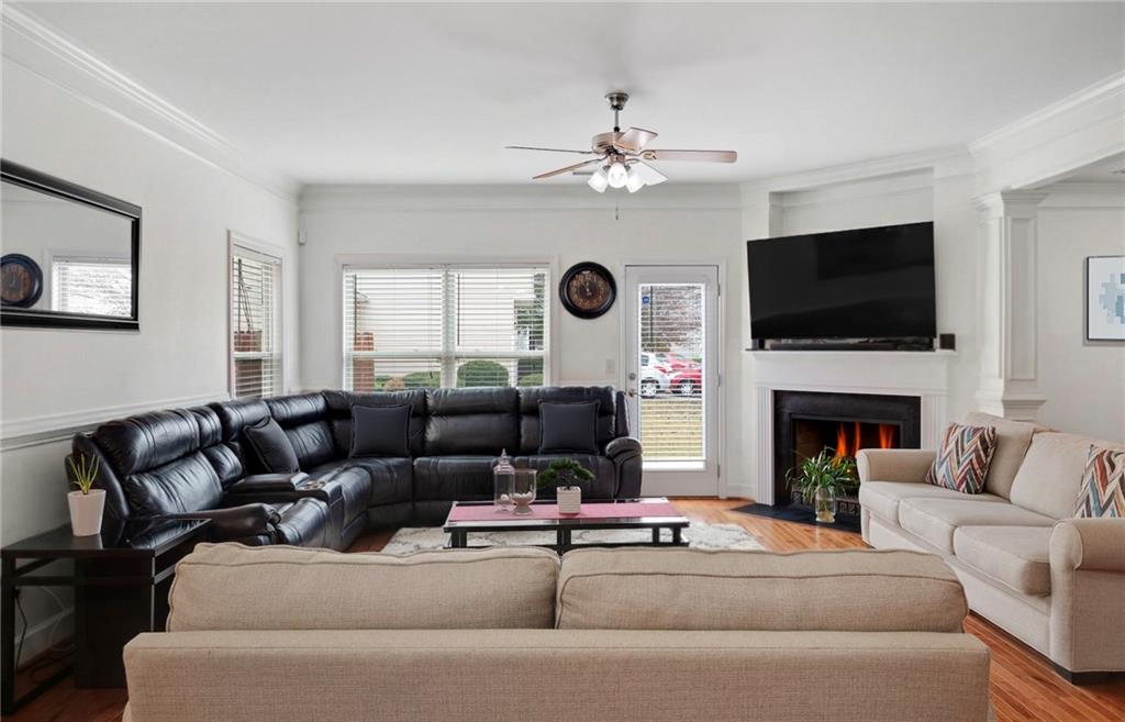 2325 Arnold Mill Road Northwest Lawrenceville, GA 30044 - Photo 8 of 40 a living room with furniture a fireplace and a flat screen tv