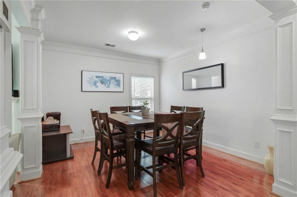 2325 Arnold Mill Road Northwest Lawrenceville, GA 30044 - Photo 10 of 40 a view of a dining room with furniture and wooden floor