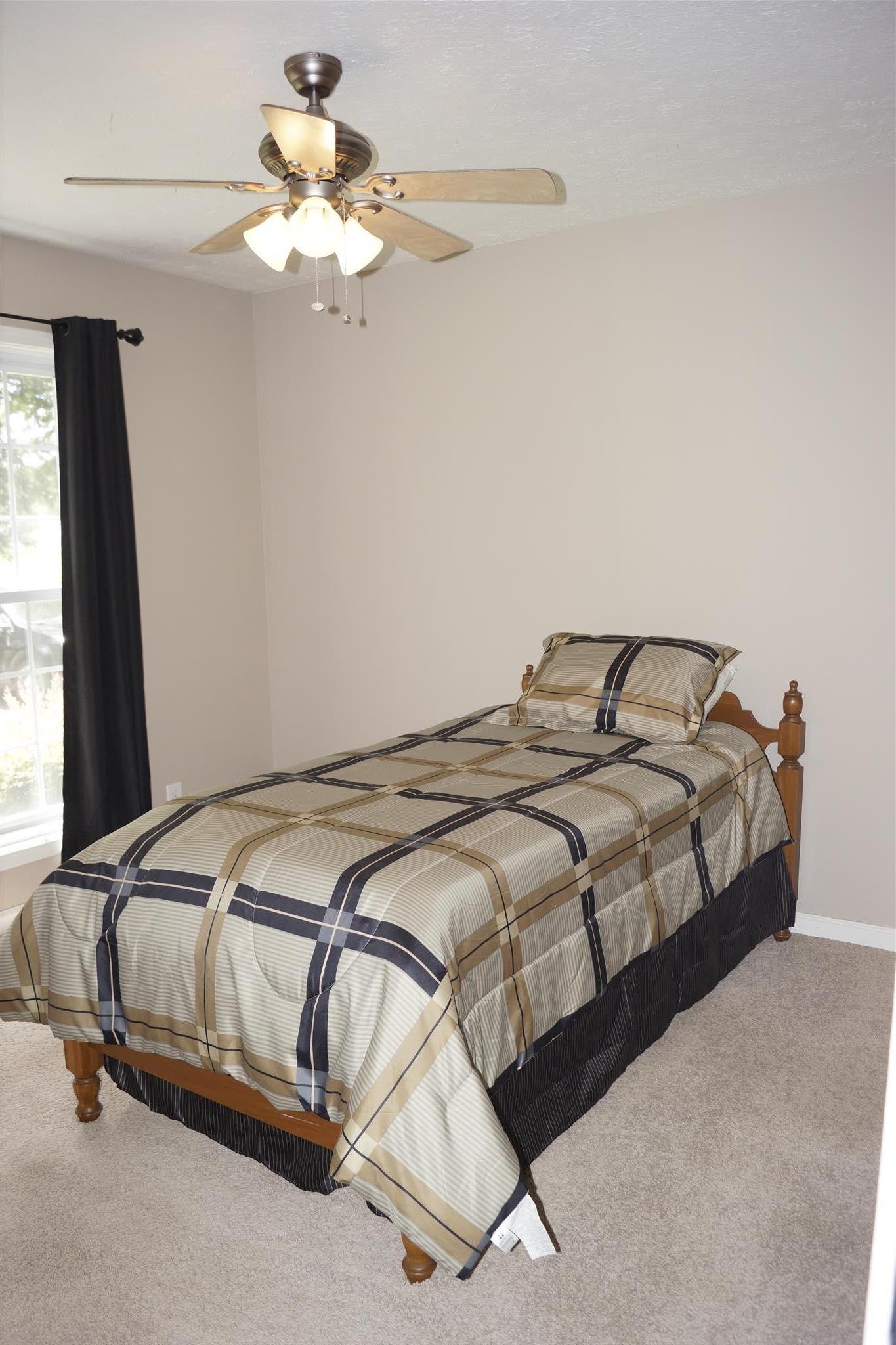 6622 Gum Station Road Springfield, TN 37172 - Photo 22 of 30 a bedroom with a bed and a chandelier