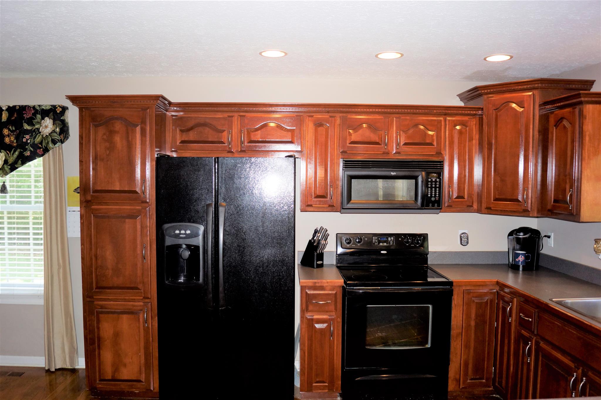 6622 Gum Station Road Springfield, TN 37172 - Photo 7 of 30 a kitchen with stainless steel appliances granite countertop a refrigerator and a sink