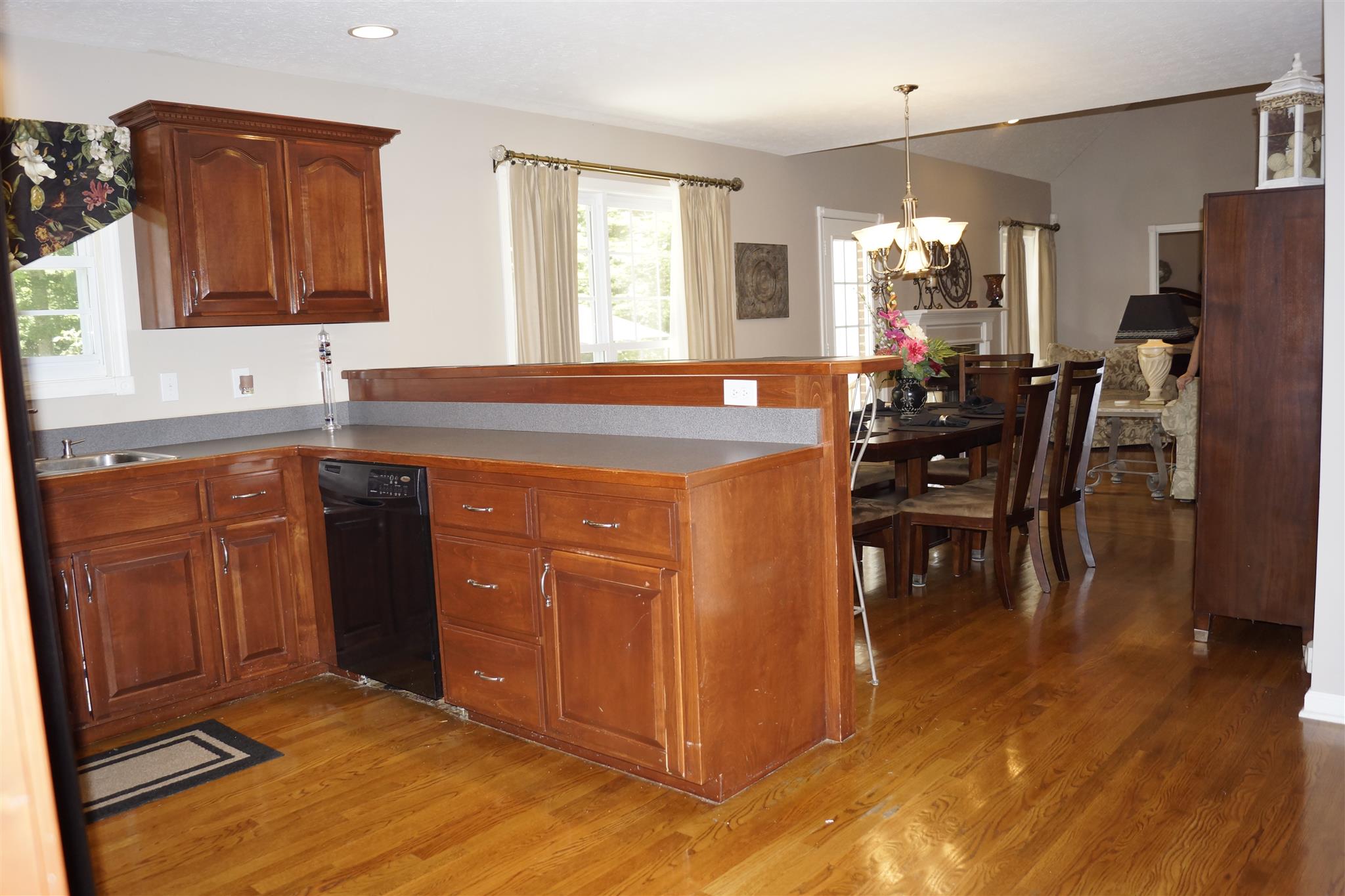 6622 Gum Station Road Springfield, TN 37172 - Photo 9 of 30 a kitchen with stainless steel appliances granite countertop a refrigerator a sink dishwasher a dining table and chairs with wooden floor