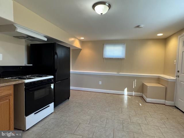 9207 4th Street Lanham, MD 20706 - Photo 5 of 14 a view of cabinets and a stove top oven