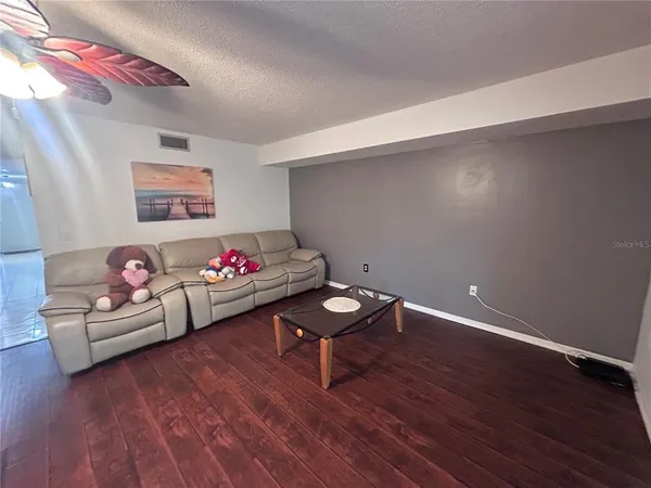 a living room with hard wood flooring and a couch