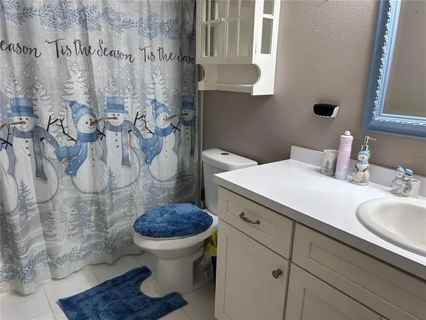 a bathroom with a granite countertop toilet and a sink