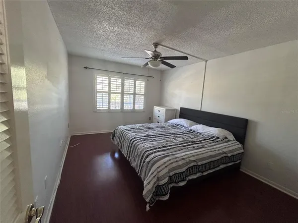 a bedroom with a bed and window