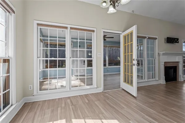 an empty room with wooden floor and a fireplace