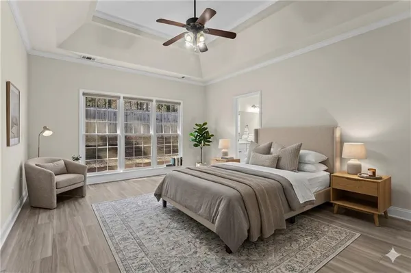 a bedroom with a large bed and a large window