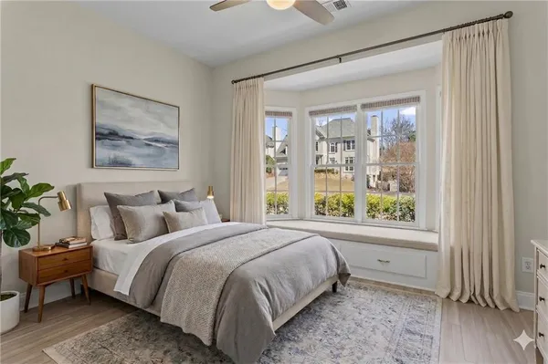 a bedroom with a large bed and a window