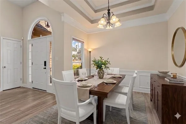 a view of a dining room with furniture and chandelier