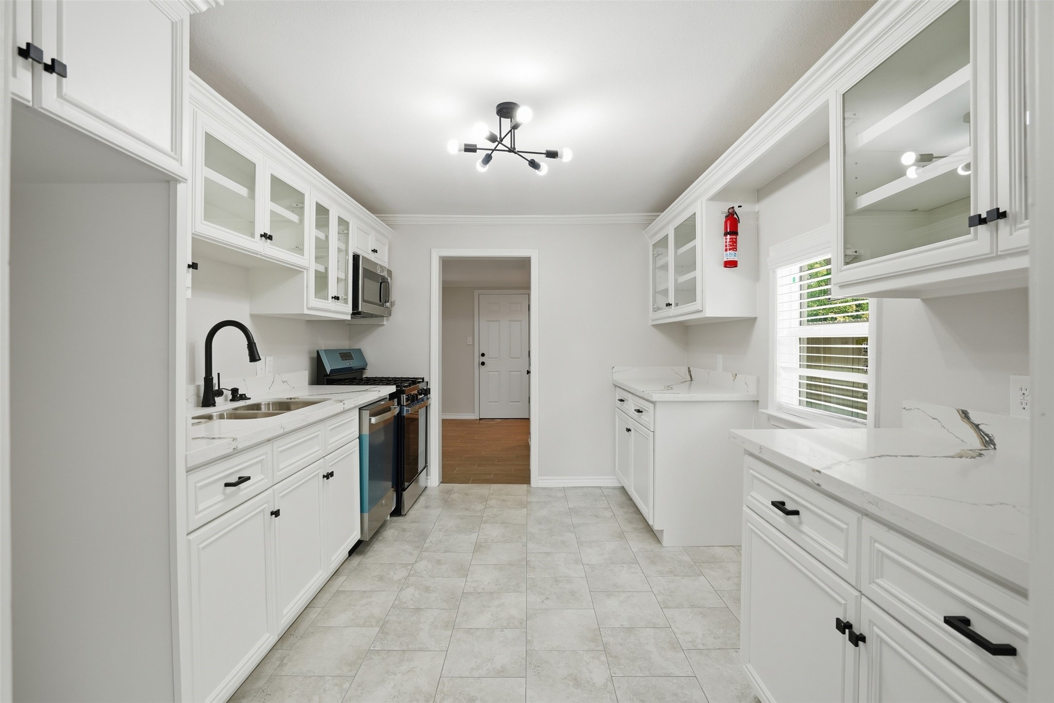 6518 Paris Street Houston, TX 77021 - Photo 11 of 23 a kitchen with a sink stove and cabinets