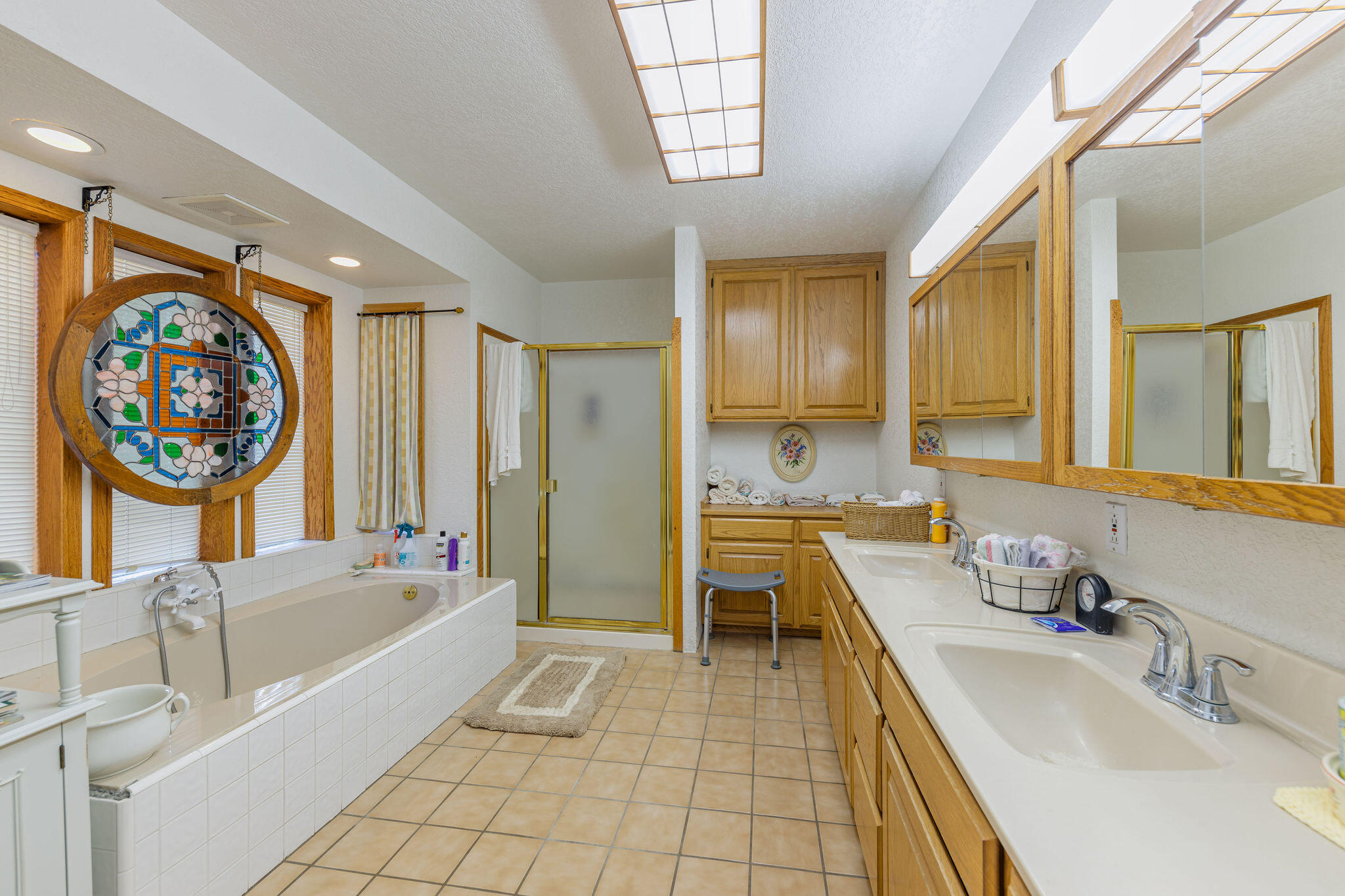 6790 Holland Loop Road Cave Junction, OR 97523 - Photo 22 of 151 a bathroom with a tub a sink a mirror and a shower