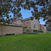 a white house that has a tree in it