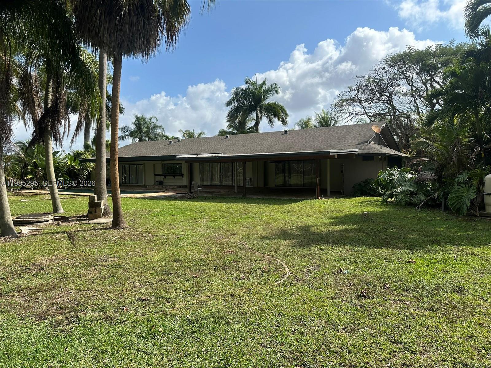 29400 Southwest 179th Avenue Homestead, FL 33030 - Photo 16 of 49 a view of a house with a yard