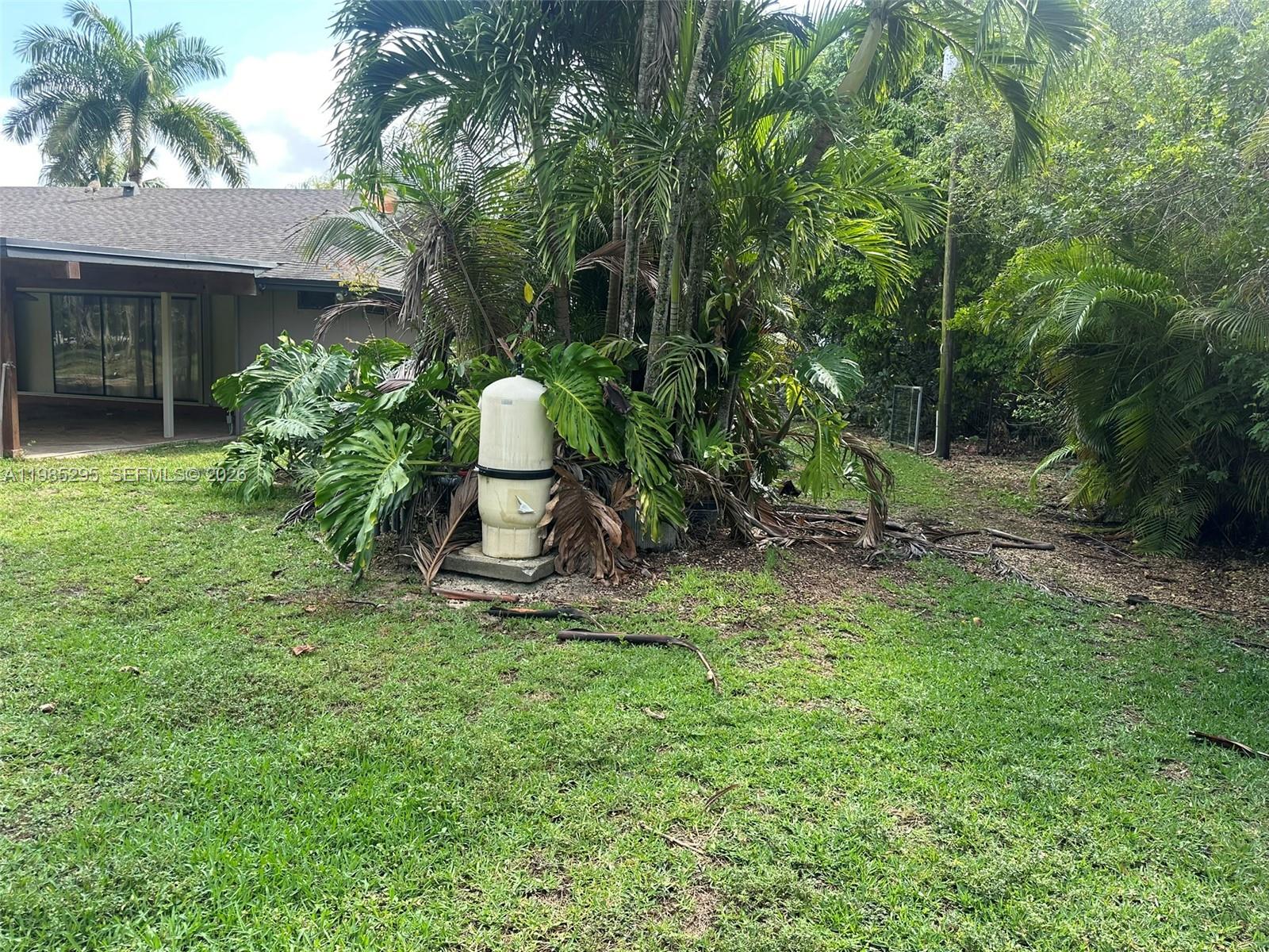 29400 Southwest 179th Avenue Homestead, FL 33030 - Photo 18 of 49 a view of a backyard with a tree
