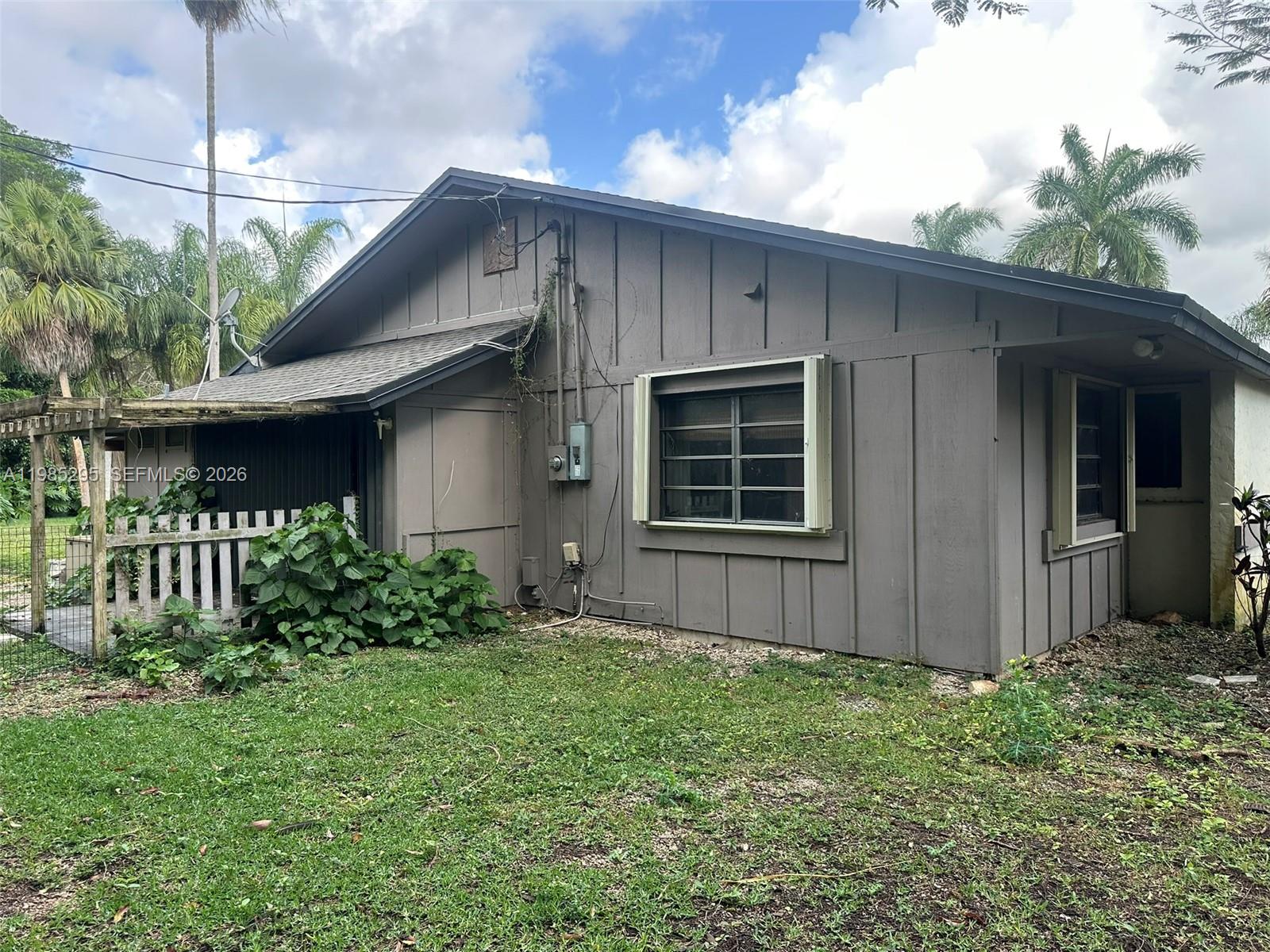 29400 Southwest 179th Avenue Homestead, FL 33030 - Photo 20 of 49 a front view of a house with garden