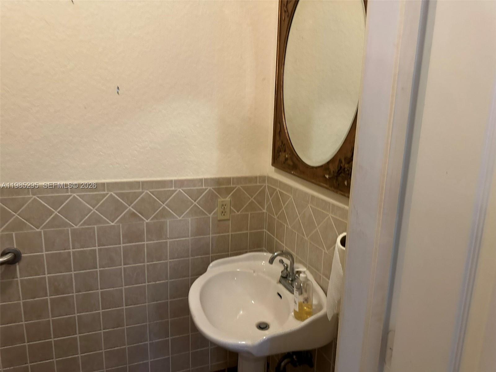 29400 Southwest 179th Avenue Homestead, FL 33030 - Photo 28 of 49 a bathroom with a sink a toilet and a mirror