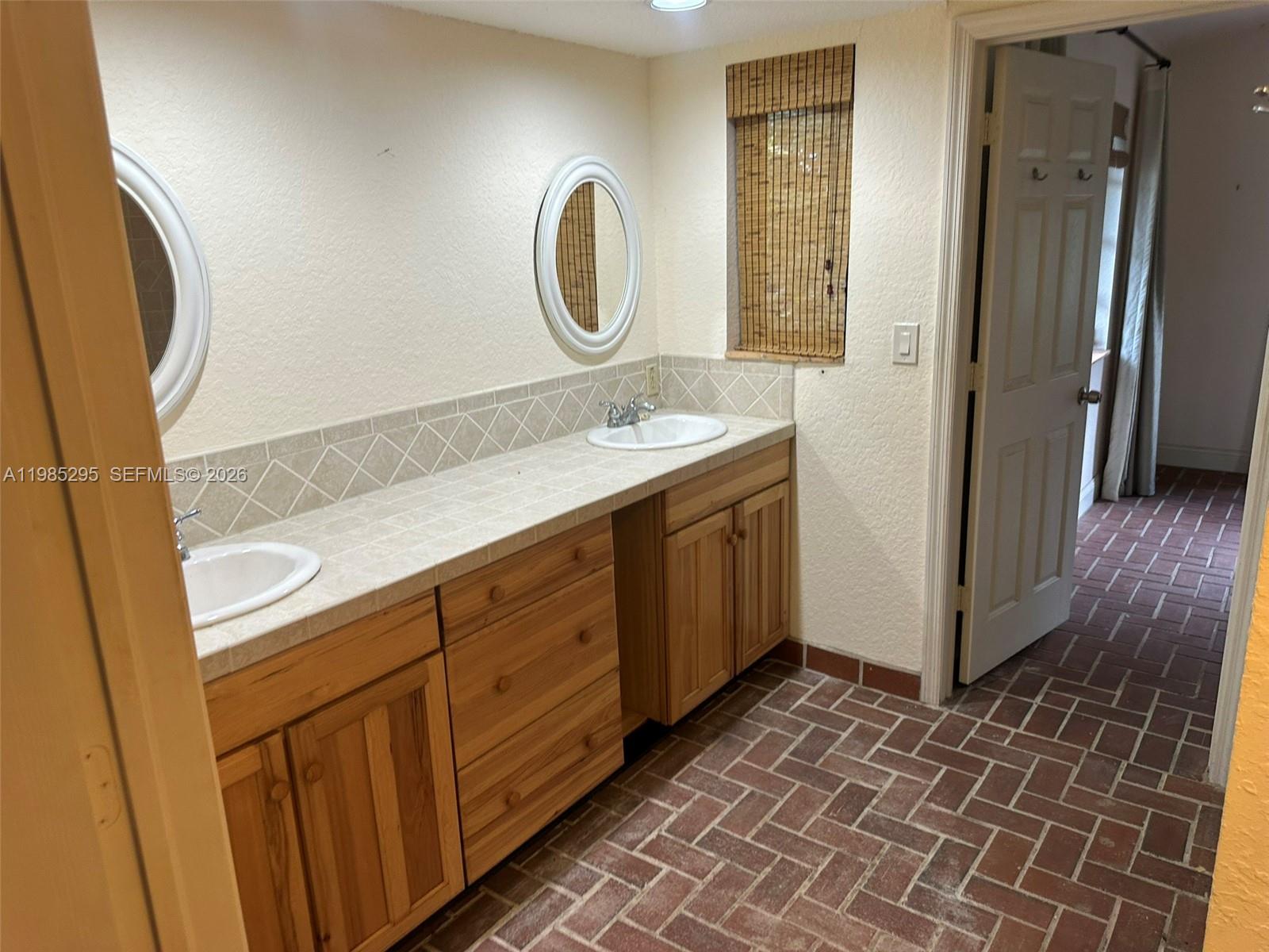29400 Southwest 179th Avenue Homestead, FL 33030 - Photo 38 of 49 a spacious bathroom with a mirror and a sink