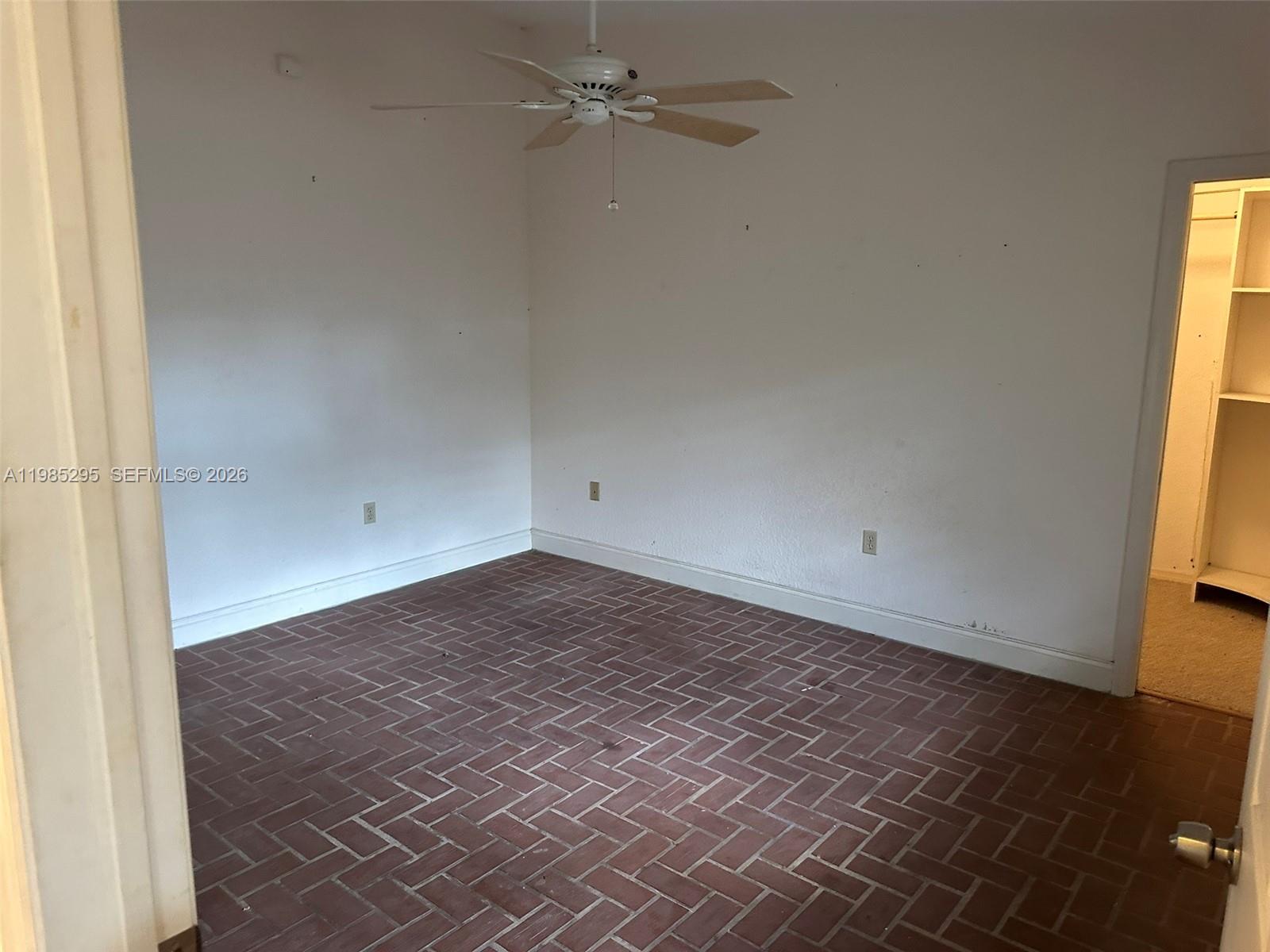 29400 Southwest 179th Avenue Homestead, FL 33030 - Photo 41 of 49 an empty room with wooden floor and windows