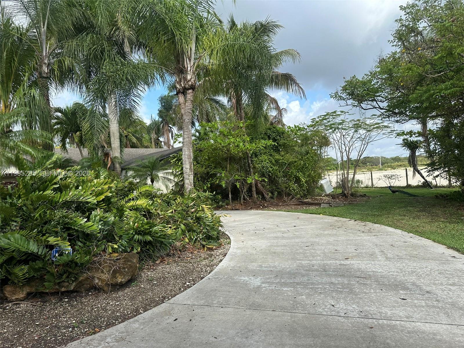 29400 Southwest 179th Avenue Homestead, FL 33030 - Photo 5 of 49 a view of a yard with plants and trees