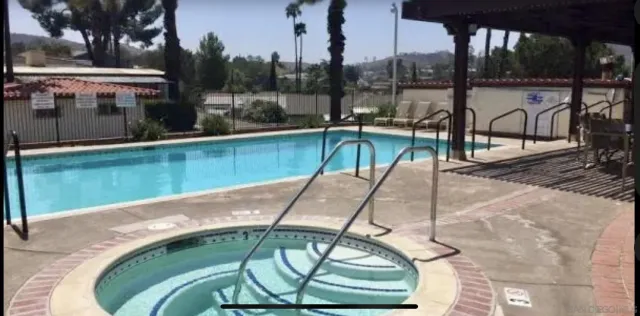 a view of a swimming pool with a patio