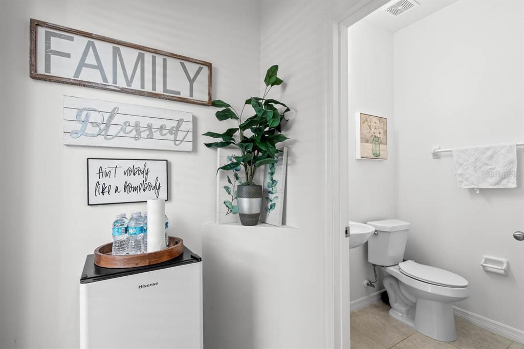 6262 Goldcoast Avenue Apollo Beach, FL 33572 - Photo 11 of 65 a bathroom with a toilet a sink and a mirror