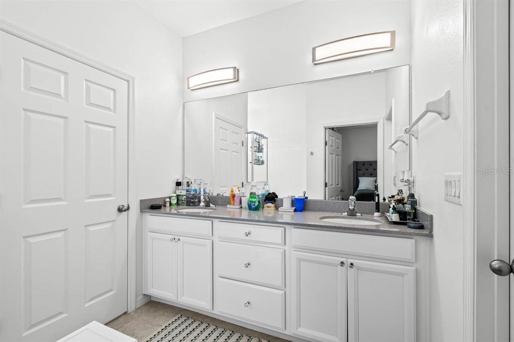 6262 Goldcoast Avenue Apollo Beach, FL 33572 - Photo 13 of 65 a bathroom with a double vanity sink and a mirror