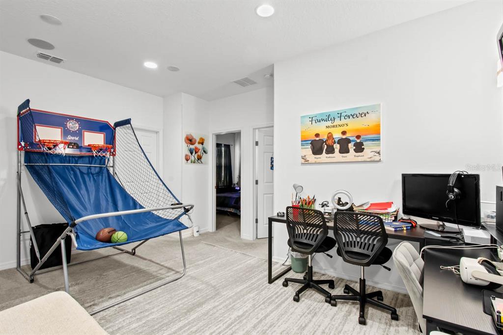 6262 Goldcoast Avenue Apollo Beach, FL 33572 - Photo 15 of 65 a view of a workspace with furniture and wooden floor