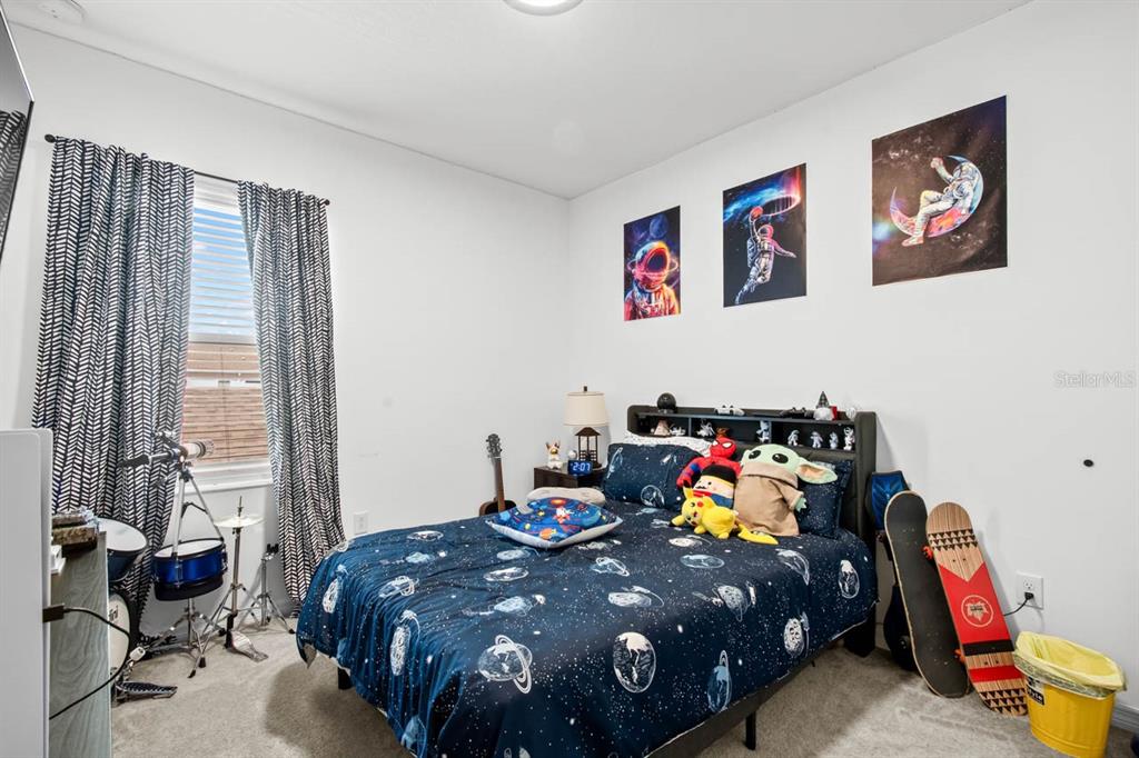 6262 Goldcoast Avenue Apollo Beach, FL 33572 - Photo 17 of 65 a bed room with a bed and a chair