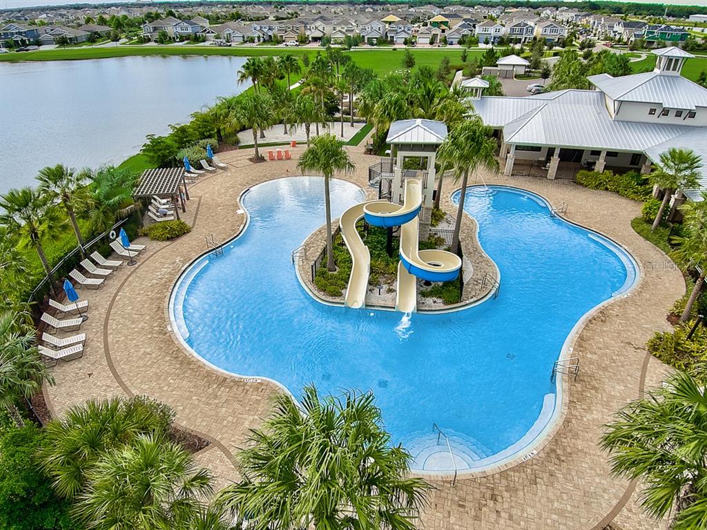 6262 Goldcoast Avenue Apollo Beach, FL 33572 - Photo 32 of 65 a view of a swimming pool with outdoor seating and lake view