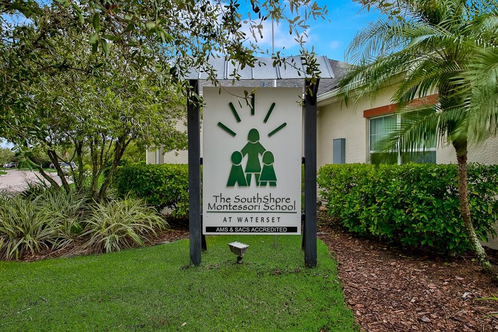 6262 Goldcoast Avenue Apollo Beach, FL 33572 - Photo 63 of 65 a view of a sign in front of a brick house with a tree