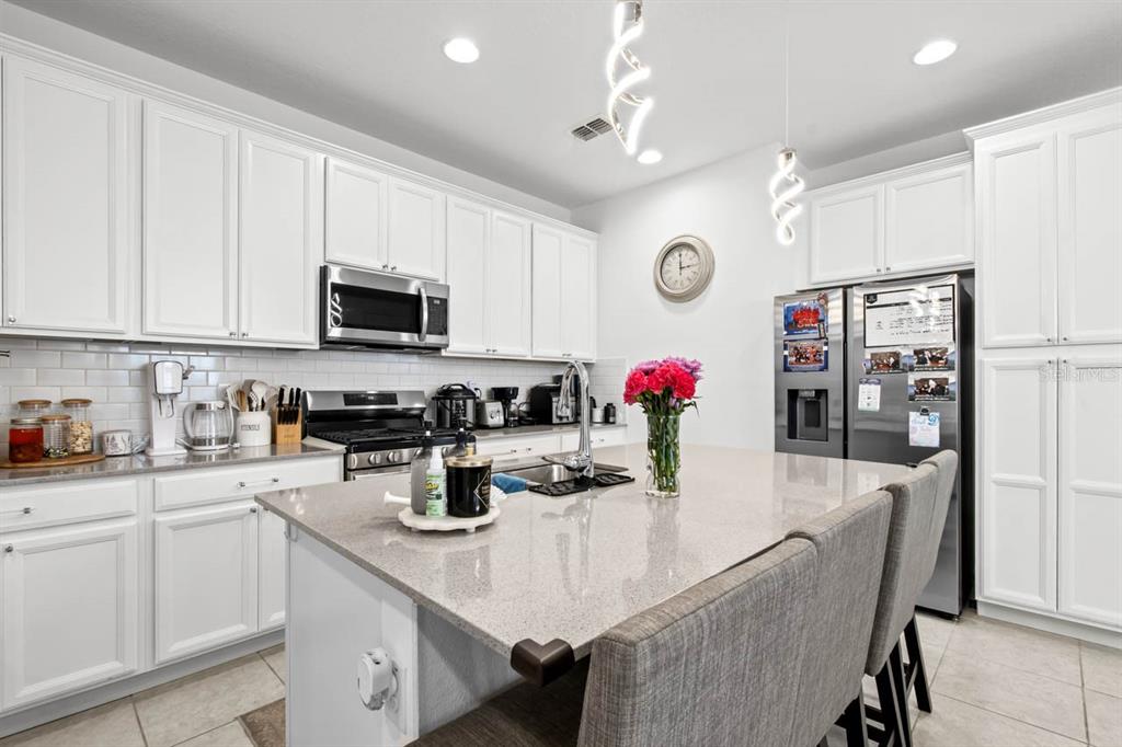 6262 Goldcoast Avenue Apollo Beach, FL 33572 - Photo 8 of 65 a kitchen with granite countertop a sink cabinets and stainless steel appliances