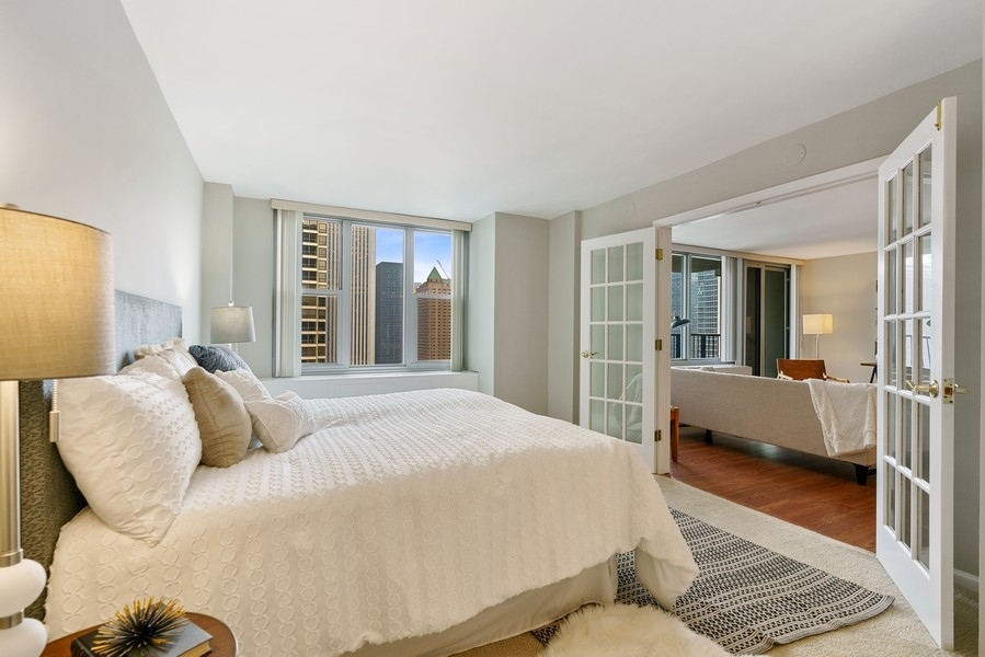 400 East Randolph Street, Unit 3324 Chicago, IL 60601 - Photo 15 of 28 a bedroom with a large bed and a couch