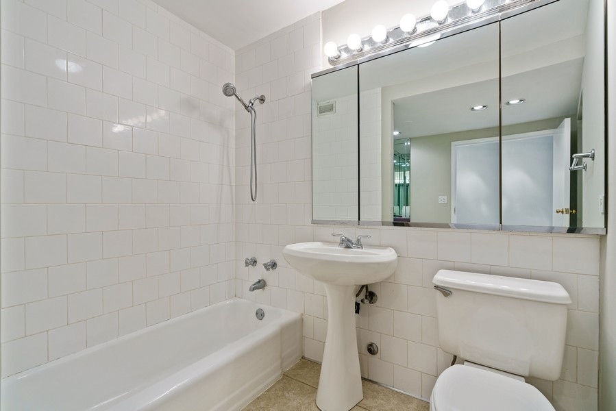 400 East Randolph Street, Unit 3324 Chicago, IL 60601 - Photo 17 of 28 a bathroom with a sink a toilet and shower