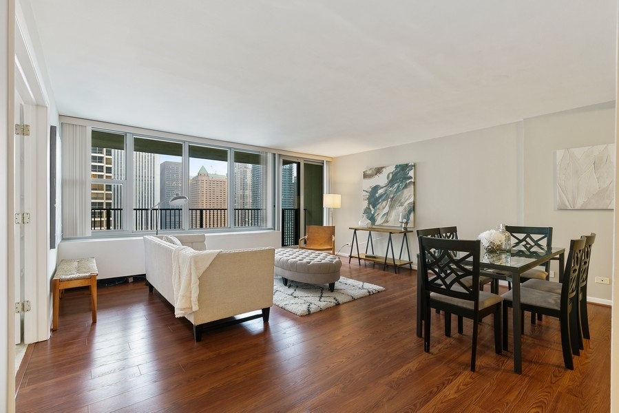 400 East Randolph Street, Unit 3324 Chicago, IL 60601 - Photo 3 of 28 a living room with furniture and wooden floor