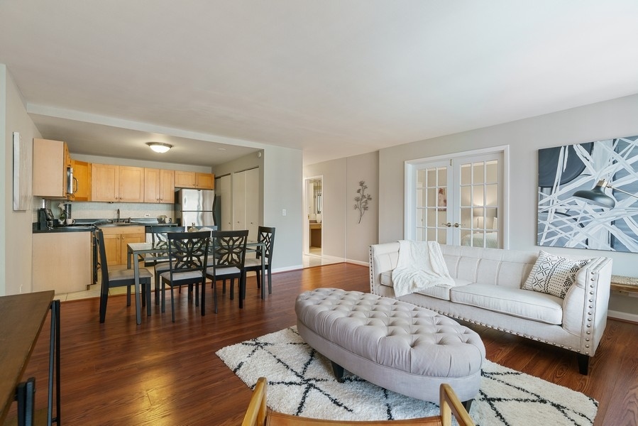 400 East Randolph Street, Unit 3324 Chicago, IL 60601 - Photo 6 of 28 a living room with furniture wooden floor and a kitchen