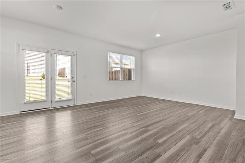 103 Rydal Way Winder, GA 30680 - Photo 13 of 31 an empty room with wooden floor and windows