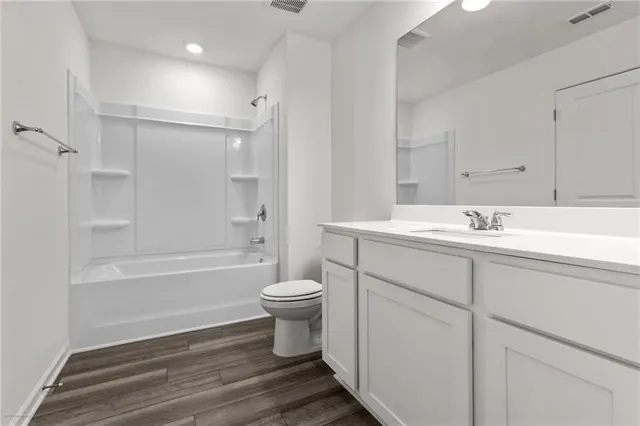 a bathroom with a sink toilet a mirror and shower
